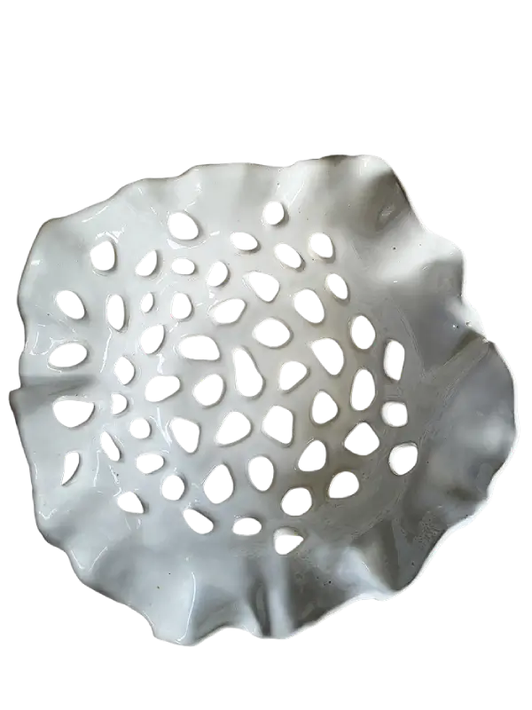white glossy ceramic bowl with holes